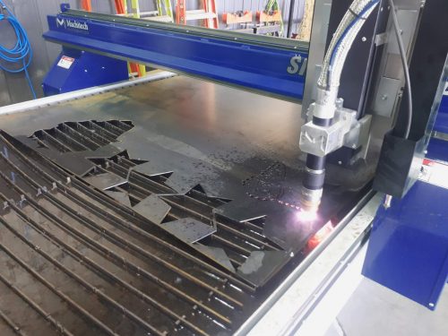 a CNC plasma torch cutting star shapes out of sheet metal
