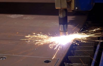 a plasma cutter processing a metal plate