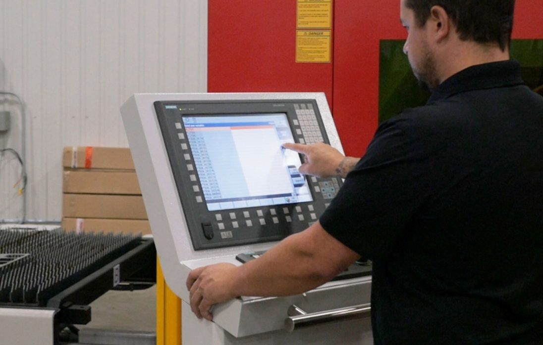 A CNC operator inputting commands